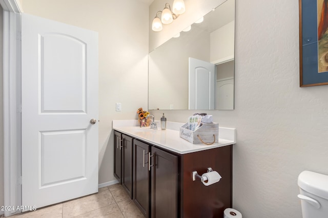 bathroom featuring tile patterned floors, vanity, and toilet