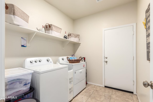 washroom featuring independent washer and dryer and light tile patterned floors