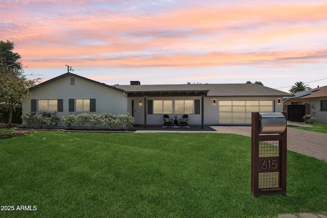 615 E Winter Dr, Phoenix, AZ 85020 - ranch-style house featuring driveway, a garage, a front yard, and stucco siding