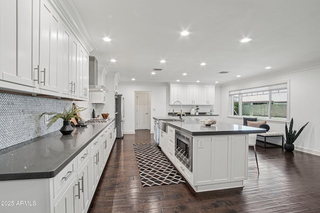 615 E Winter Dr, Phoenix, AZ 85020 - kitchen featuring dark countertops, wall chimney range hood, appliances with stainless steel finishes, ornamental molding, and recessed lighting