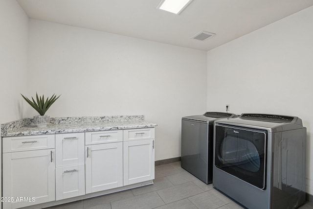 615 E Winter Dr, Phoenix, AZ 85020 - laundry room with washing machine and clothes dryer, cabinet space, and light tile patterned floors