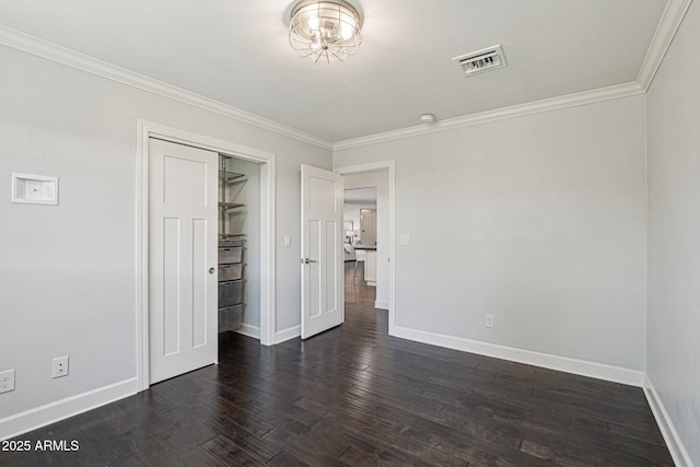615 E Winter Dr, Phoenix, AZ 85020 - unfurnished bedroom featuring crown molding, dark wood finished floors, and a closet