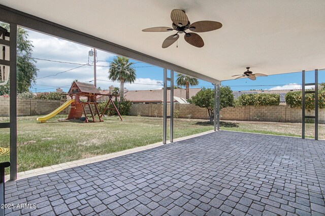 615 E Winter Dr, Phoenix, AZ 85020 - fenced backyard featuring ceiling fan, a playground, and a patio