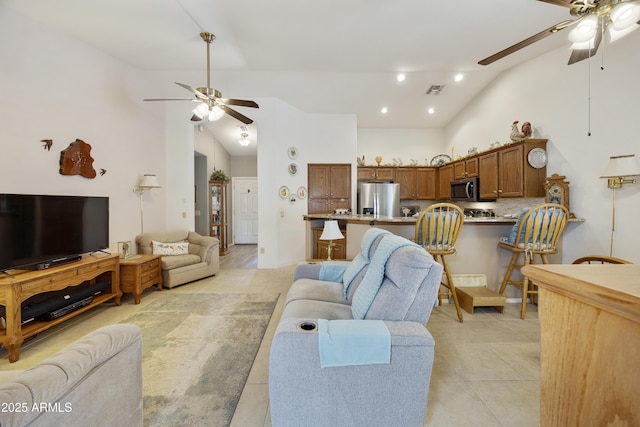 living room featuring a ceiling fan, light tile patterned floors, high vaulted ceiling, and recessed lighting