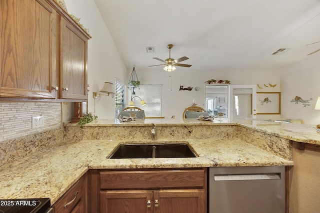 kitchen featuring stainless steel dishwasher, a ceiling fan, a sink, and stove
