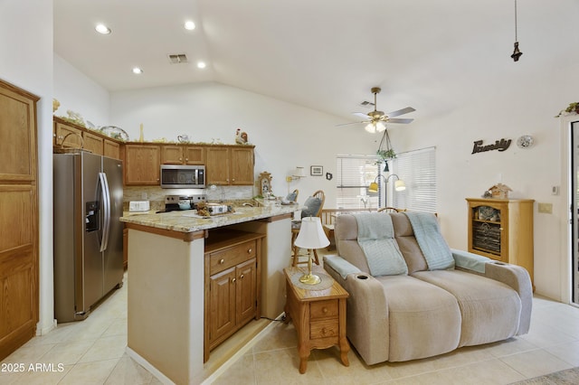 kitchen featuring stainless steel appliances, light tile patterned floors, open floor plan, a ceiling fan, and lofted ceiling
