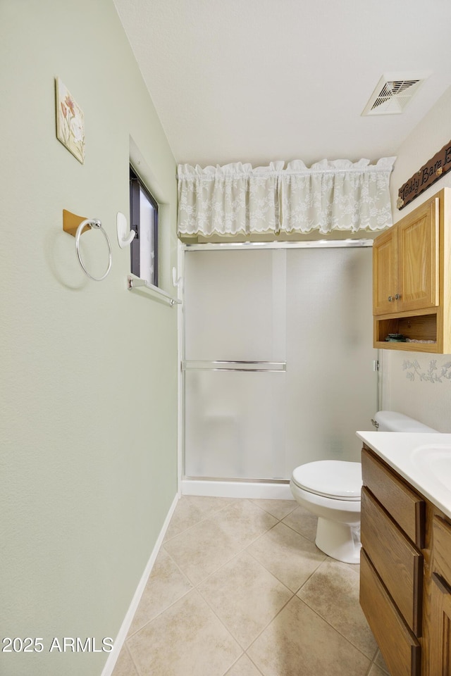 bathroom featuring tile patterned flooring, toilet, vanity, and baseboards