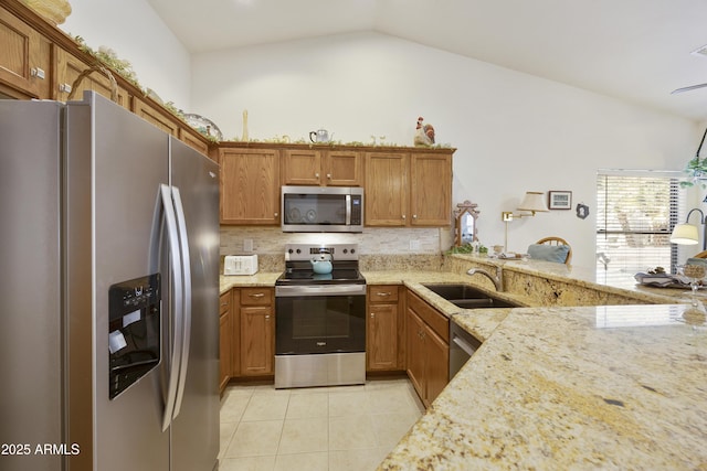 kitchen with stainless steel appliances, a sink, lofted ceiling, light tile patterned floors, and backsplash