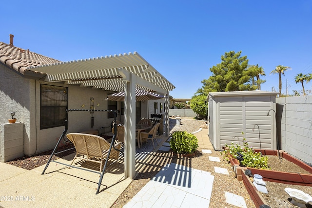 view of patio with a shed, outdoor dining space, an outdoor structure, and a fenced backyard