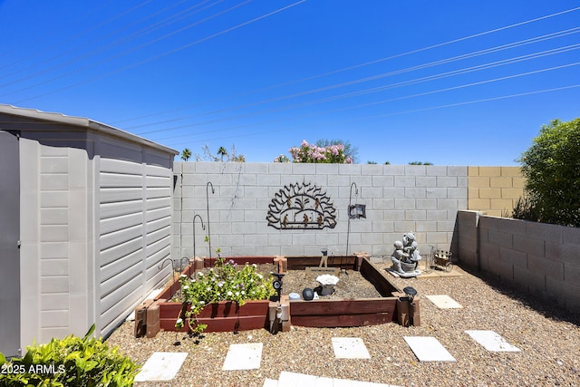 exterior view of a fenced backyard and a garden