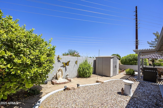 fenced backyard with a storage unit, a pergola, an outbuilding, and a patio