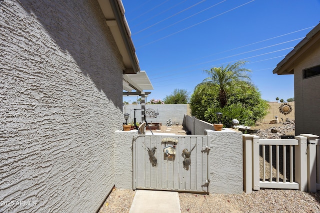 view of home's exterior featuring a fenced backyard and a gate