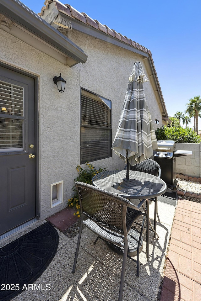 view of patio / terrace with outdoor dining space and a grill