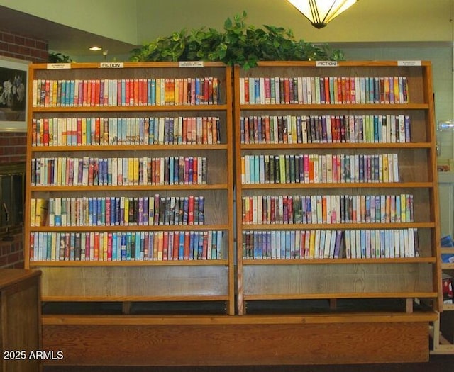 sitting room featuring wall of books