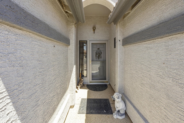 entrance to property with stucco siding