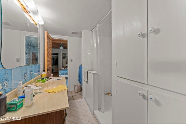 bathroom with vanity, a shower with shower curtain, and tile patterned floors