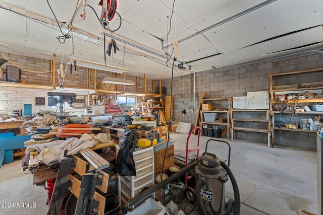 garage featuring a garage door opener and a workshop area