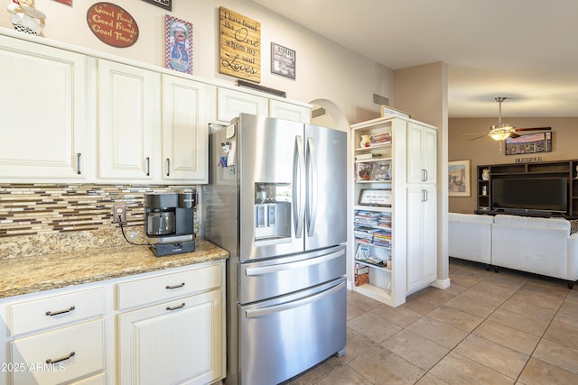 kitchen featuring stainless steel fridge, tasteful backsplash, ceiling fan, white cabinetry, and light tile patterned flooring
