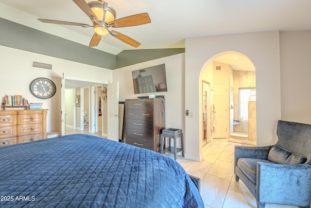 bedroom featuring visible vents, vaulted ceiling, arched walkways, and ensuite bathroom