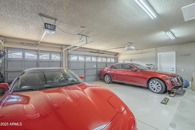 garage with concrete block wall and a garage door opener