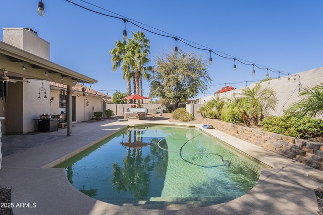 view of pool featuring a patio, a fenced backyard, and a fenced in pool