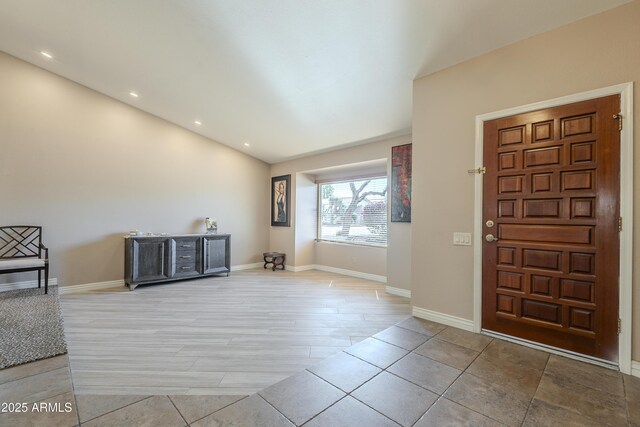 foyer entrance with recessed lighting and baseboards