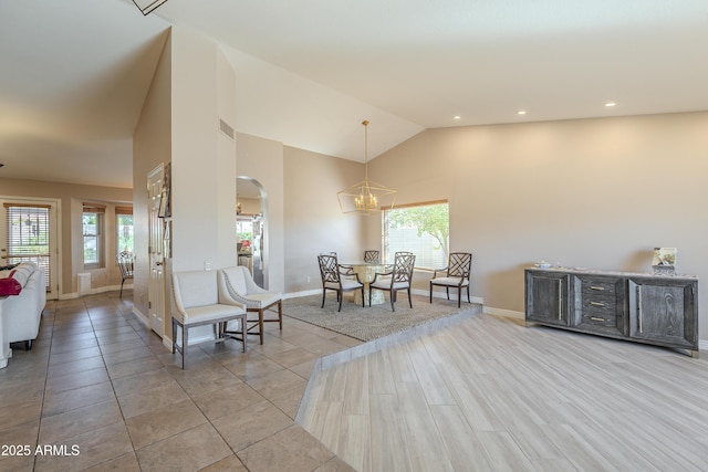 dining room featuring high vaulted ceiling, a healthy amount of sunlight, and visible vents