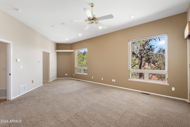 unfurnished bedroom with multiple windows, carpet floors, and ceiling fan