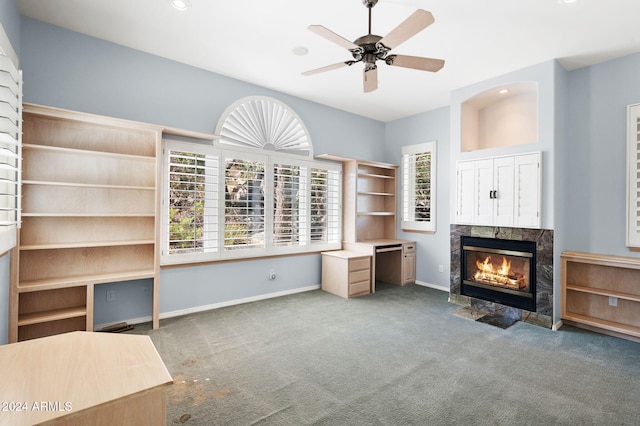 unfurnished living room with carpet, ceiling fan, and a fireplace