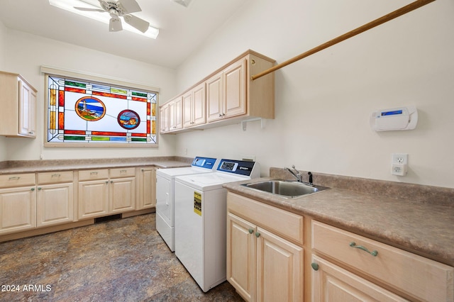 clothes washing area featuring ceiling fan, sink, washer and dryer, and cabinets