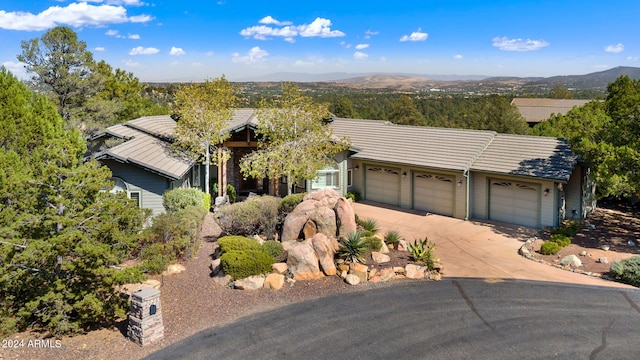 view of front of home with a mountain view and a garage