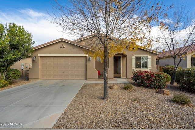 ranch-style house featuring concrete driveway, a tile roof, a garage, and stucco siding