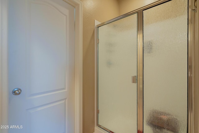 bathroom with a shower stall