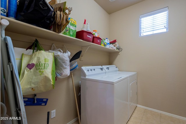 washroom with independent washer and dryer, laundry area, light tile patterned floors, and baseboards