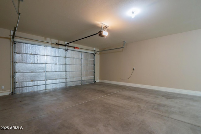garage featuring a garage door opener and baseboards