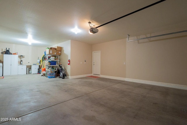 garage with baseboards and a garage door opener