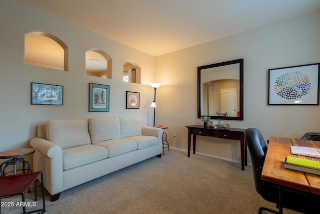 carpeted office space featuring baseboards
