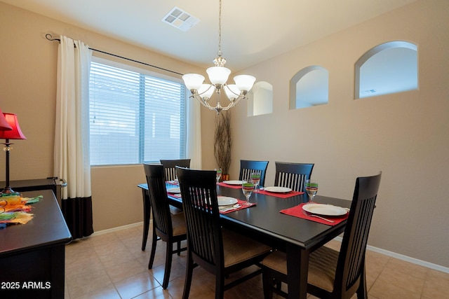 dining space featuring an inviting chandelier, baseboards, and visible vents