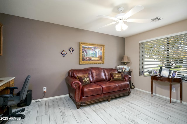 home office featuring light wood-type flooring and ceiling fan