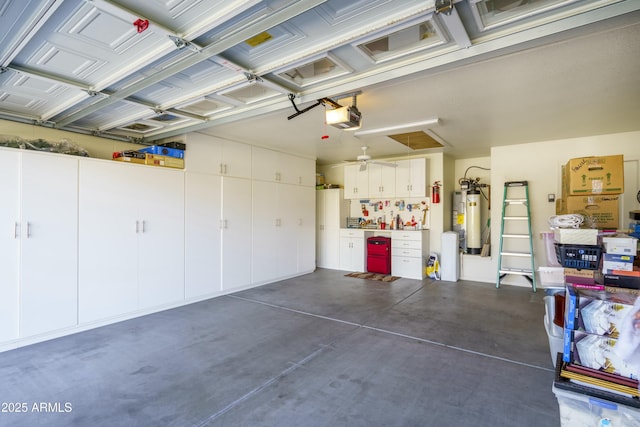 garage featuring a garage door opener and electric water heater