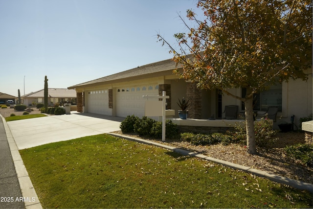 view of front of property with a garage and a front lawn