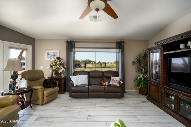 living room featuring light hardwood / wood-style flooring, ceiling fan, vaulted ceiling, and a healthy amount of sunlight