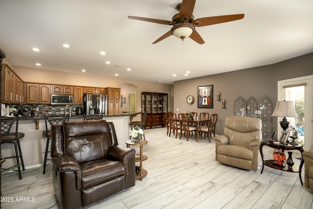 living room featuring ceiling fan and light hardwood / wood-style floors