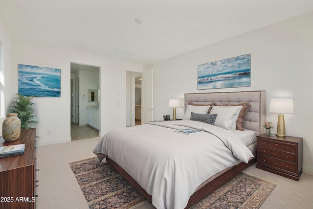 carpeted bedroom with ensuite bathroom