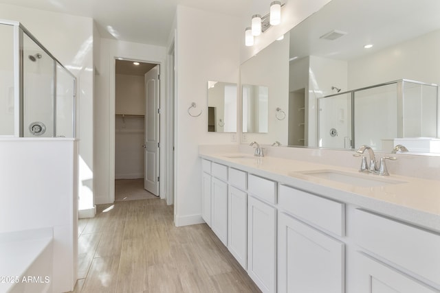 bathroom with hardwood / wood-style flooring, vanity, and separate shower and tub