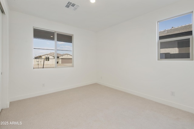 carpeted empty room with a wealth of natural light