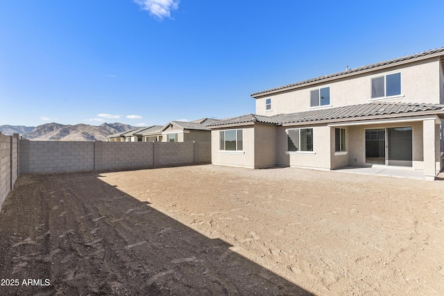 rear view of house featuring a mountain view