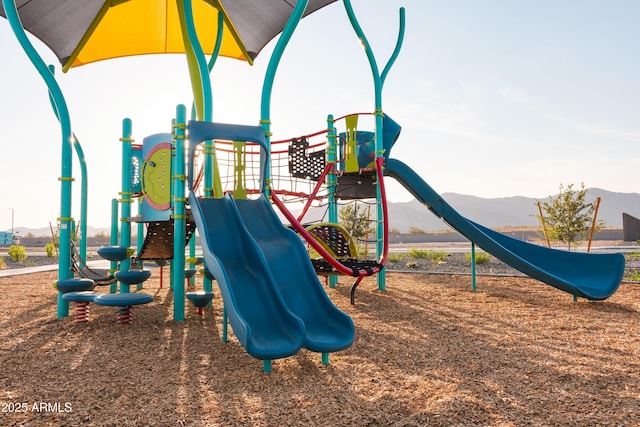 view of jungle gym featuring a mountain view