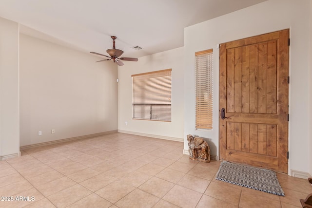 tiled entryway with ceiling fan