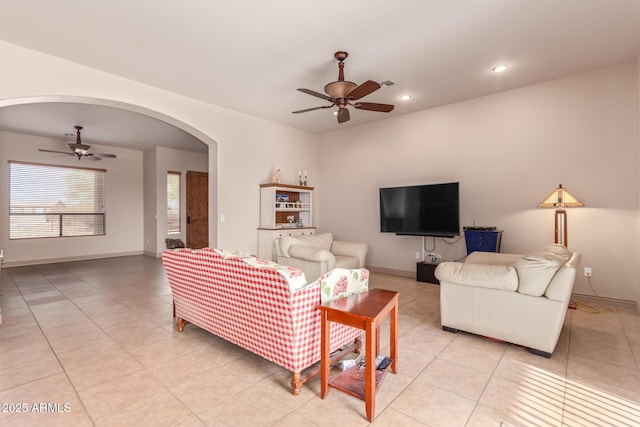 tiled living room with ceiling fan